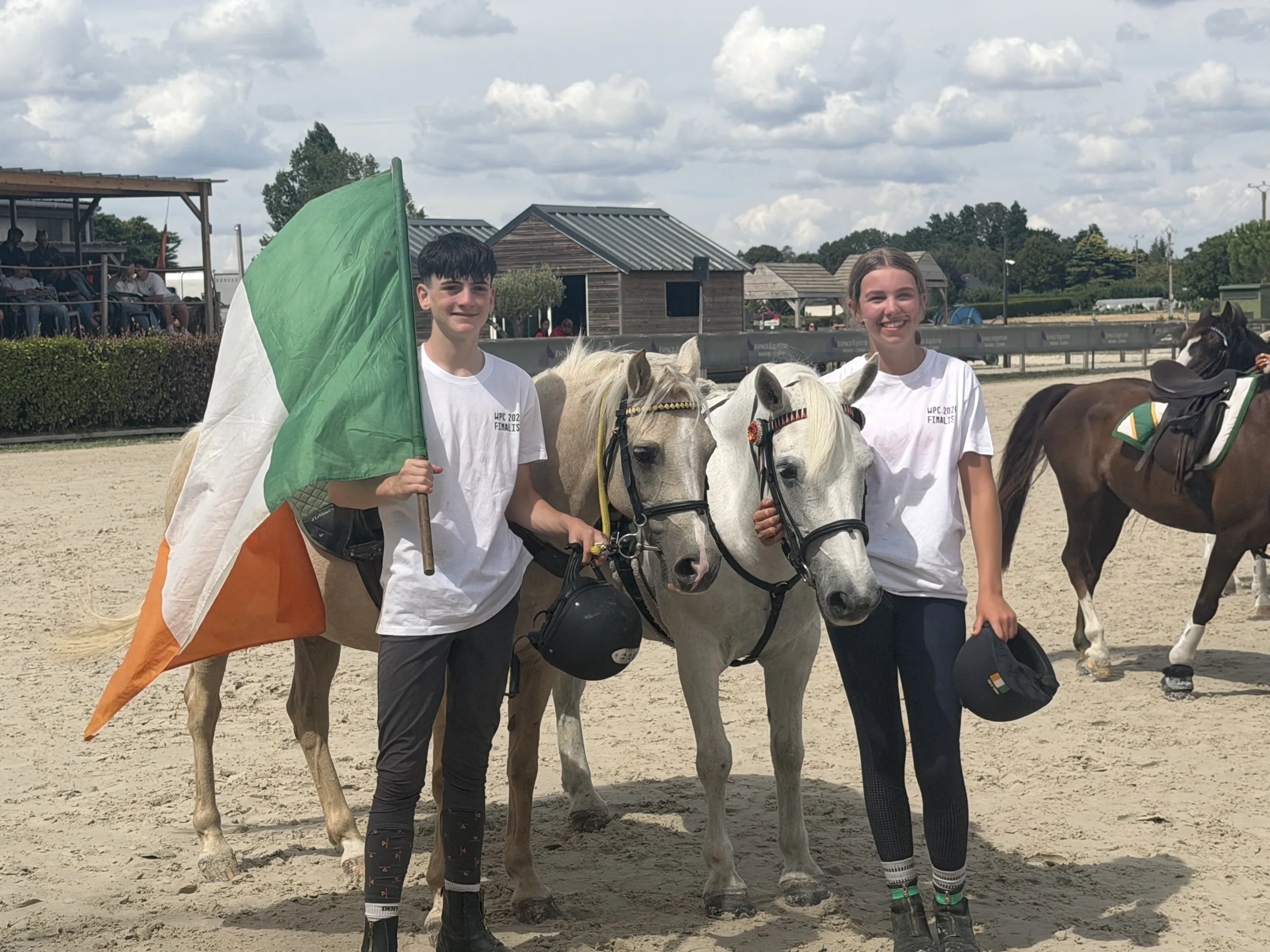 World Pairs Champions - Mikey and Grace with their ponies and the Irish flag at Angers.